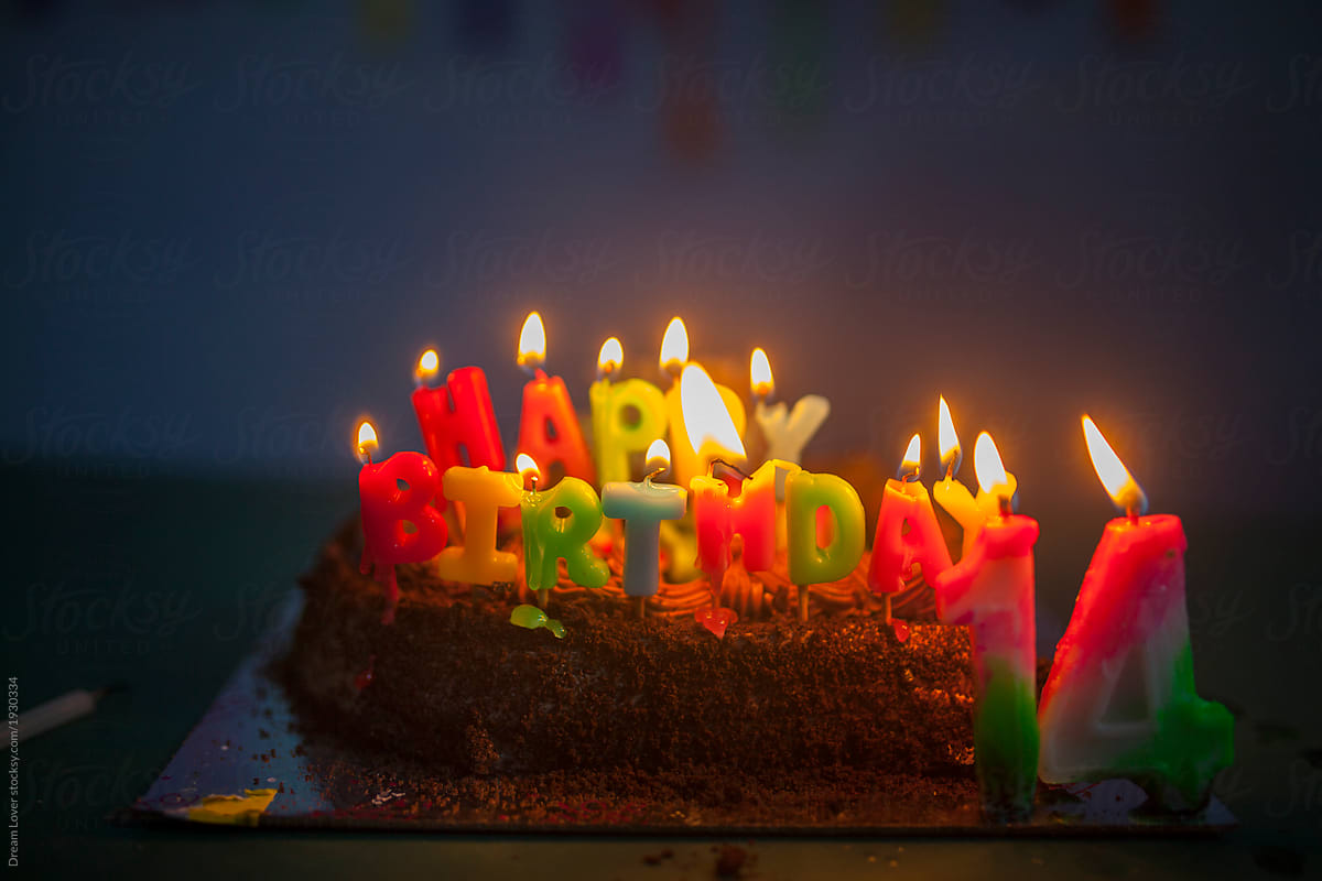 Birthday cake with happy birthday candle burning