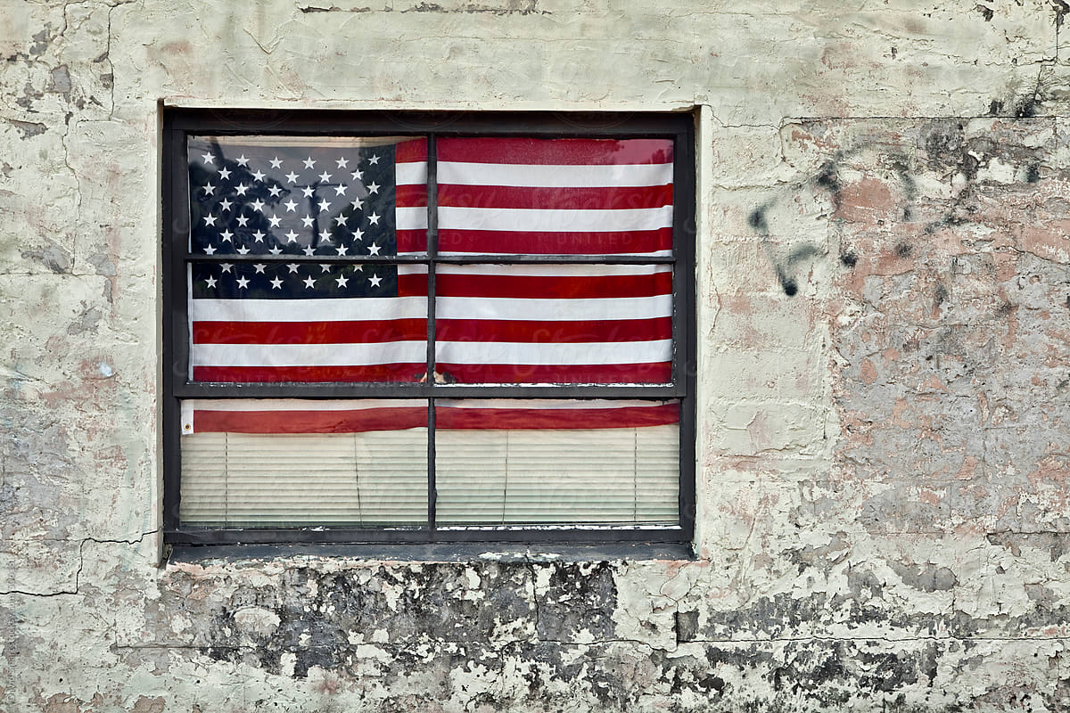 USA Flag in the window of a grungy building