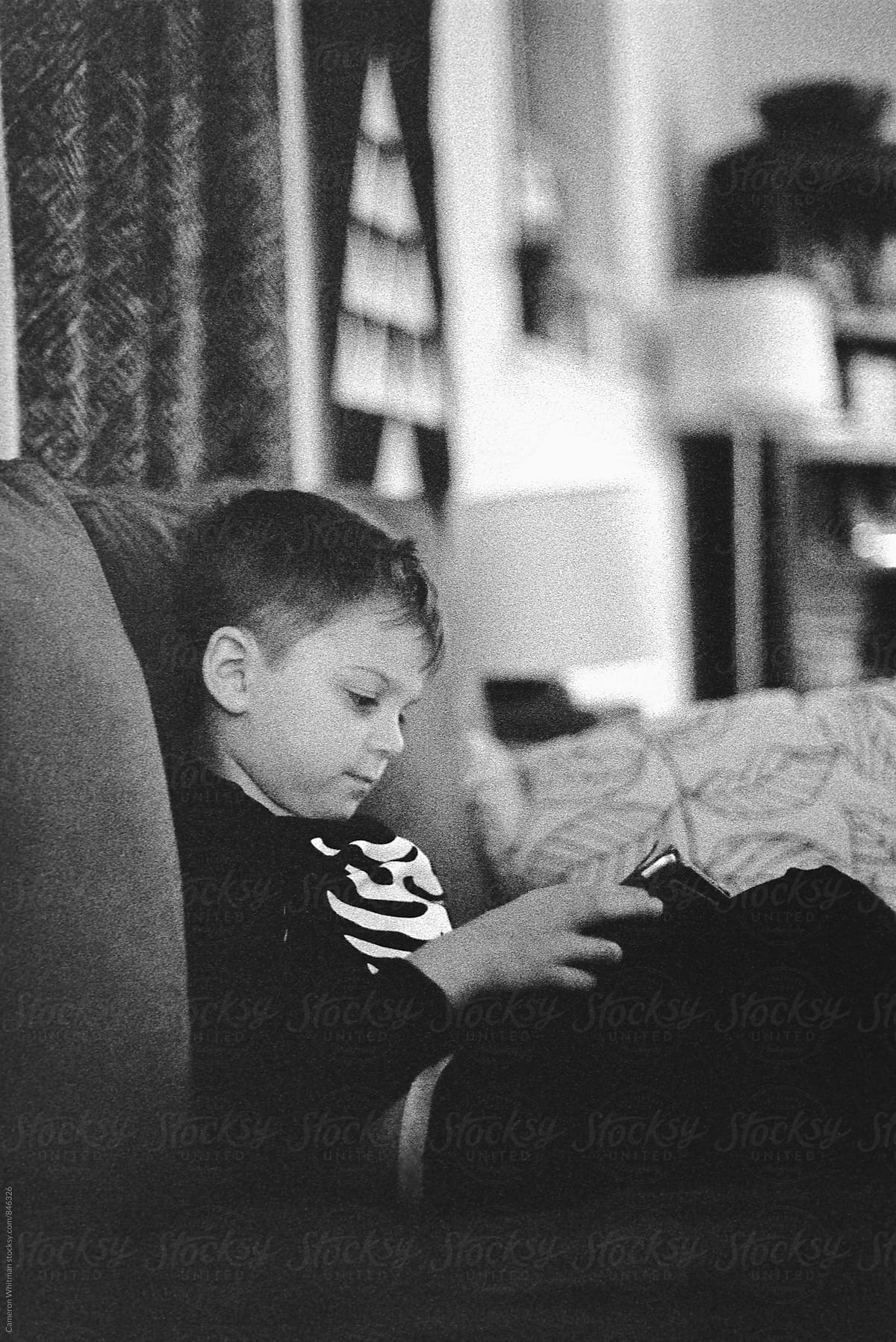 Young boy using tablet device in his PJ\'s