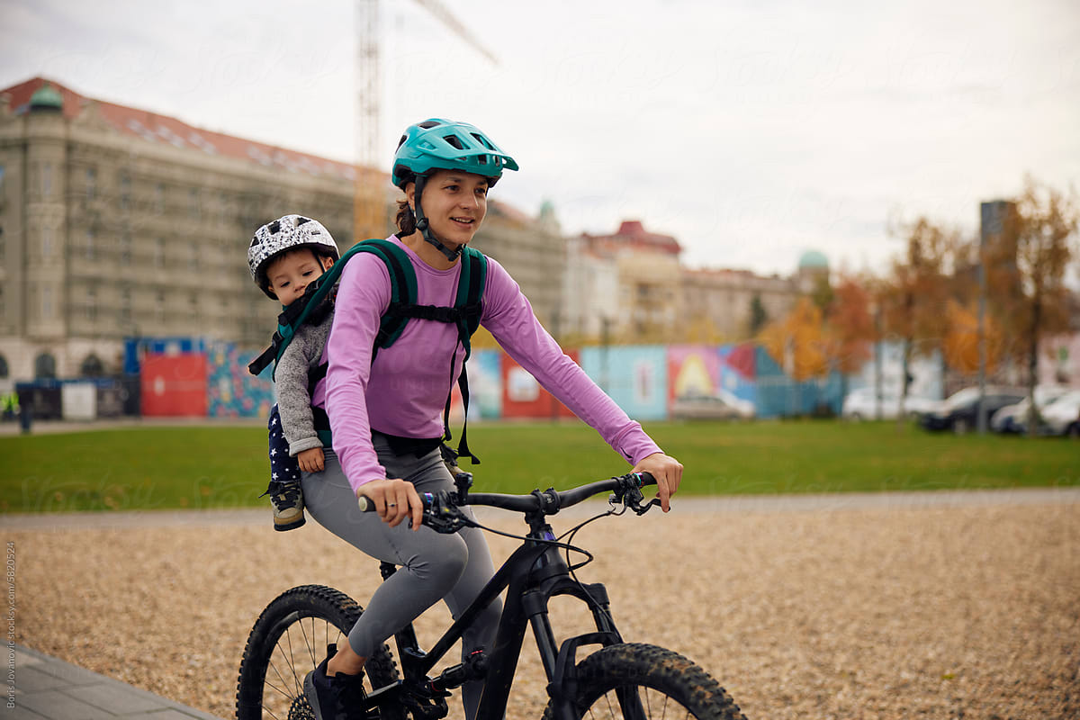 Sportswoman cycling with her child