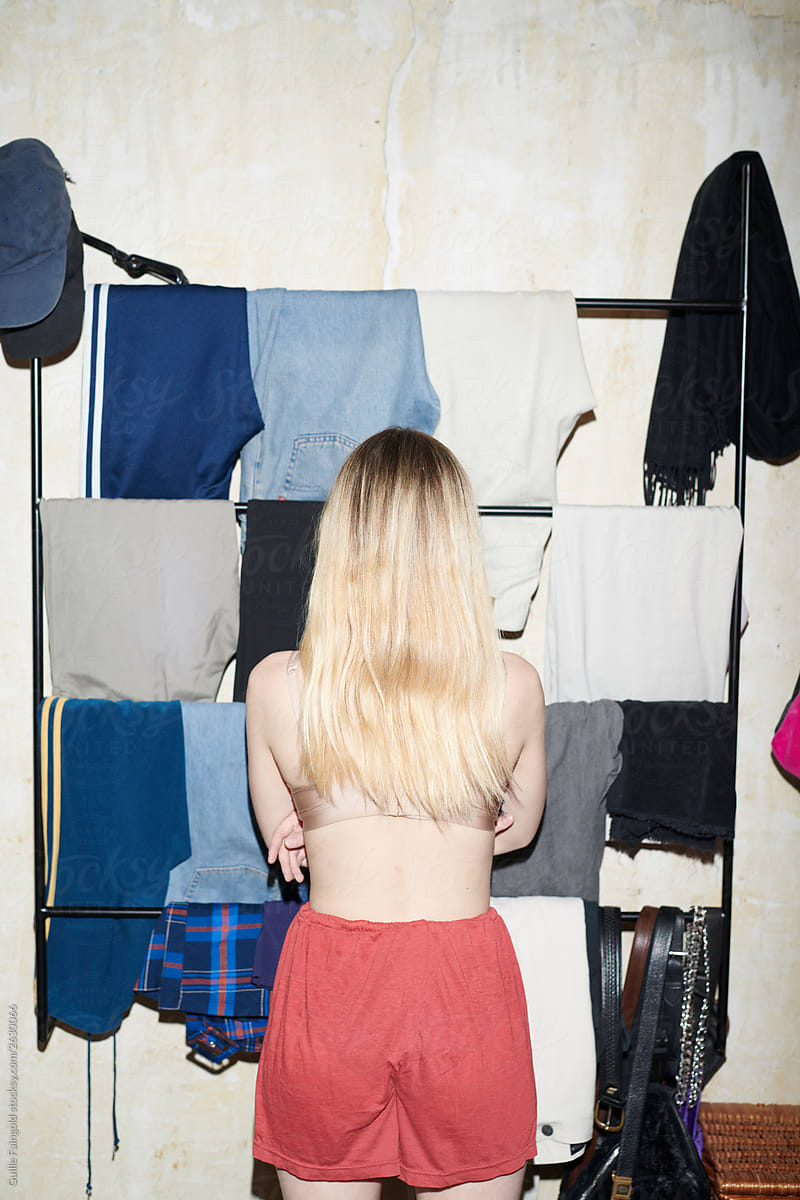 Woman standing in front of rack with clothes