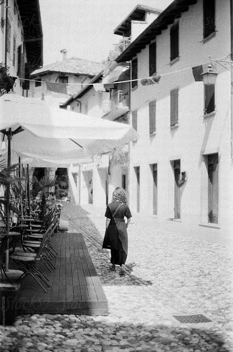 Al woman walking on a italian street