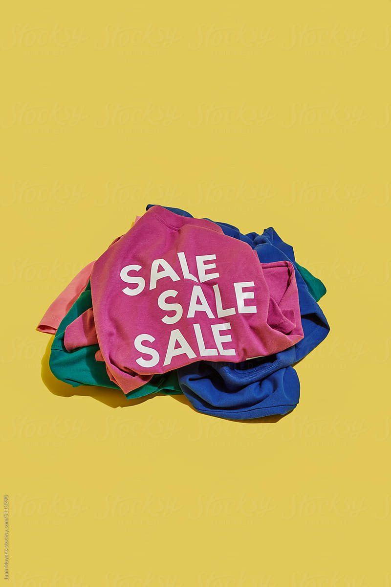 t-shirt with the word sale on top of a pile of shirts