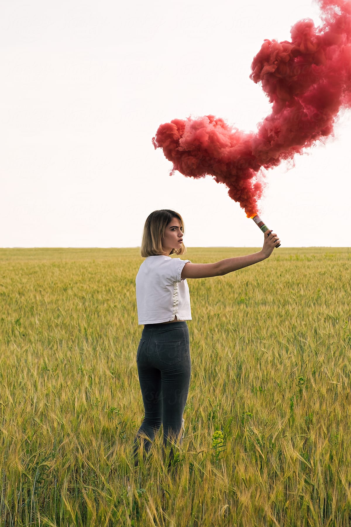 Fil atlet erindringsmønter Serious Teen Girl With Red Smoke Bomb On Meadow" by Stocksy Contributor  "Danil Nevsky" - Stocksy
