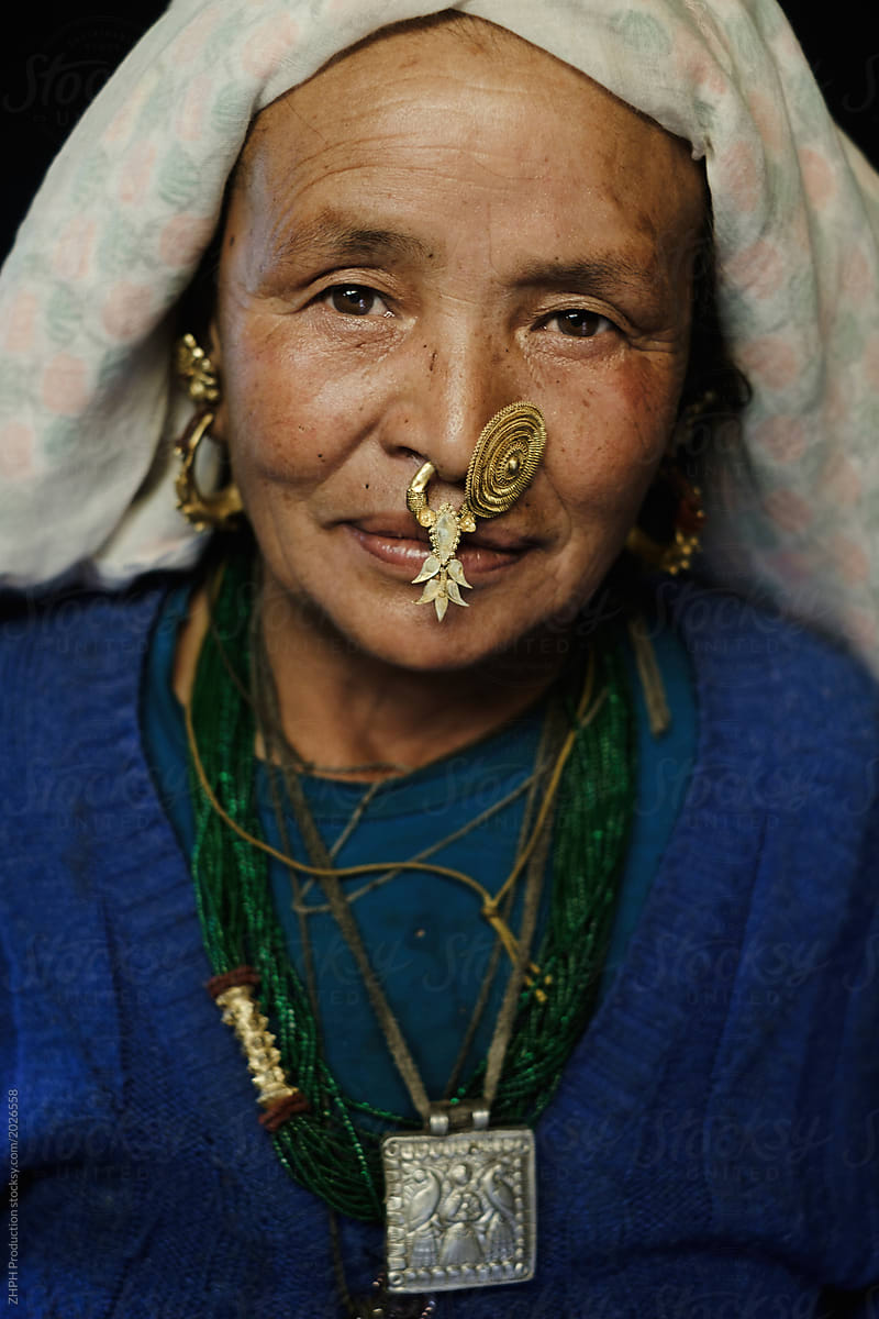 Portrait on black Nepali elderly Tamang woman