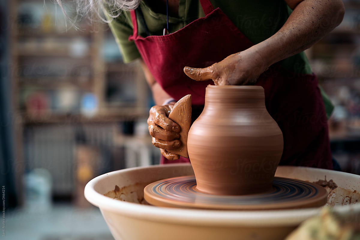 Woman Making Pottery On Spinning Wheel