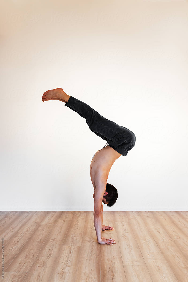 Flexible gymnast doing handstand