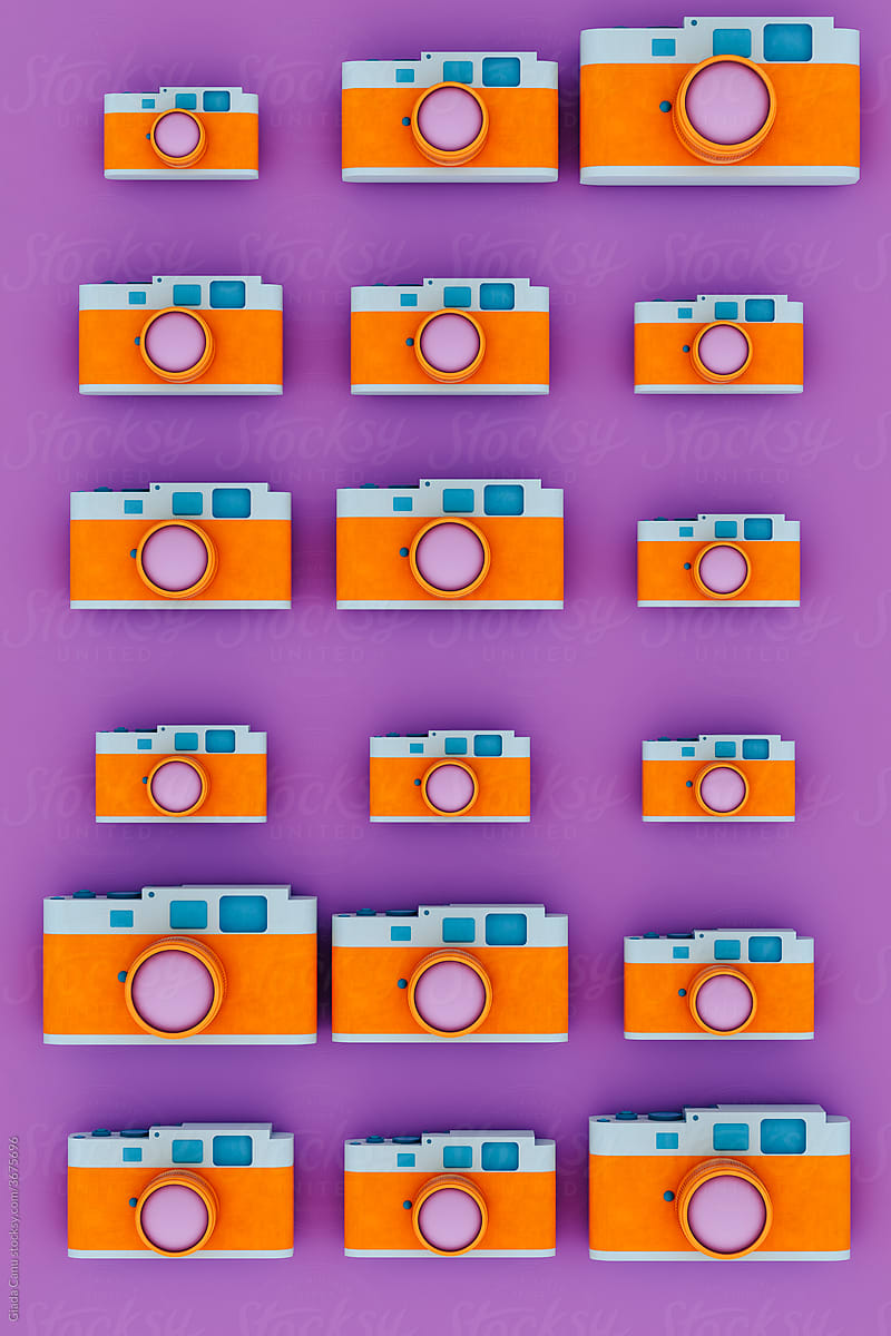 top down view of Orange and blue camera on violet background