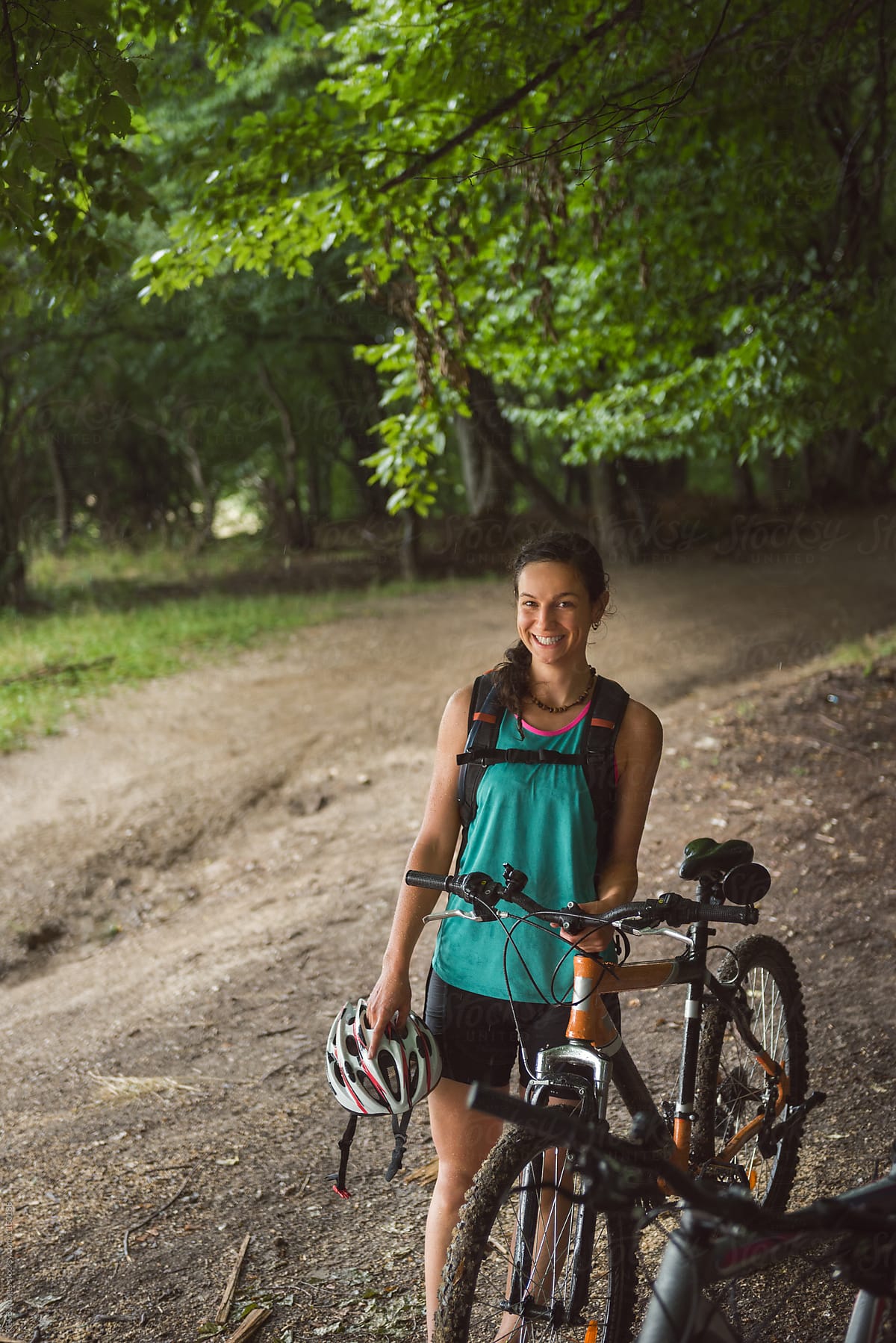  Young Woman Enjoying A Bicycle Trip Through The Forest By Stocksy Contributor Ibex media 