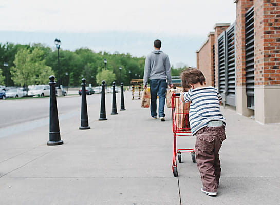 Little Girl Pushes Shopping Cart Down Sidewalk In Underwear by Stocksy  Contributor Maria Manco - Stocksy