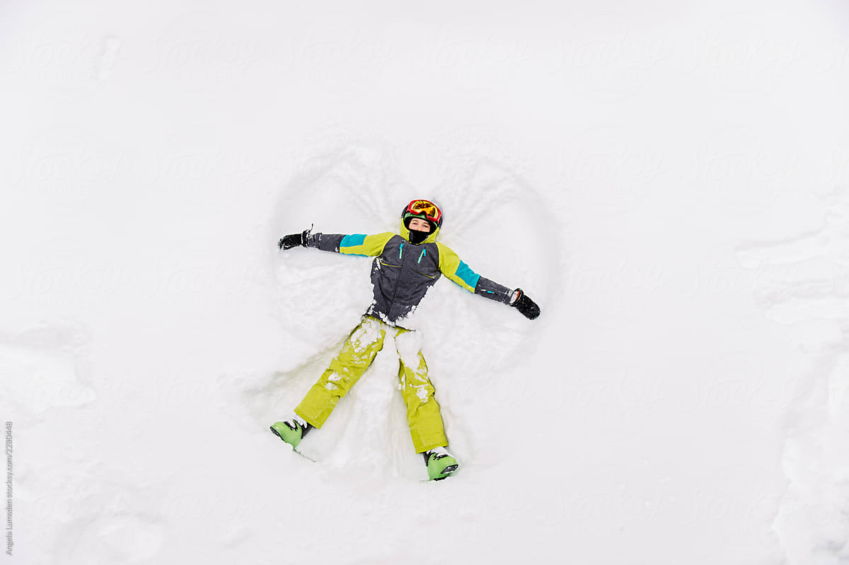 Child making a snow angel, viewed from above