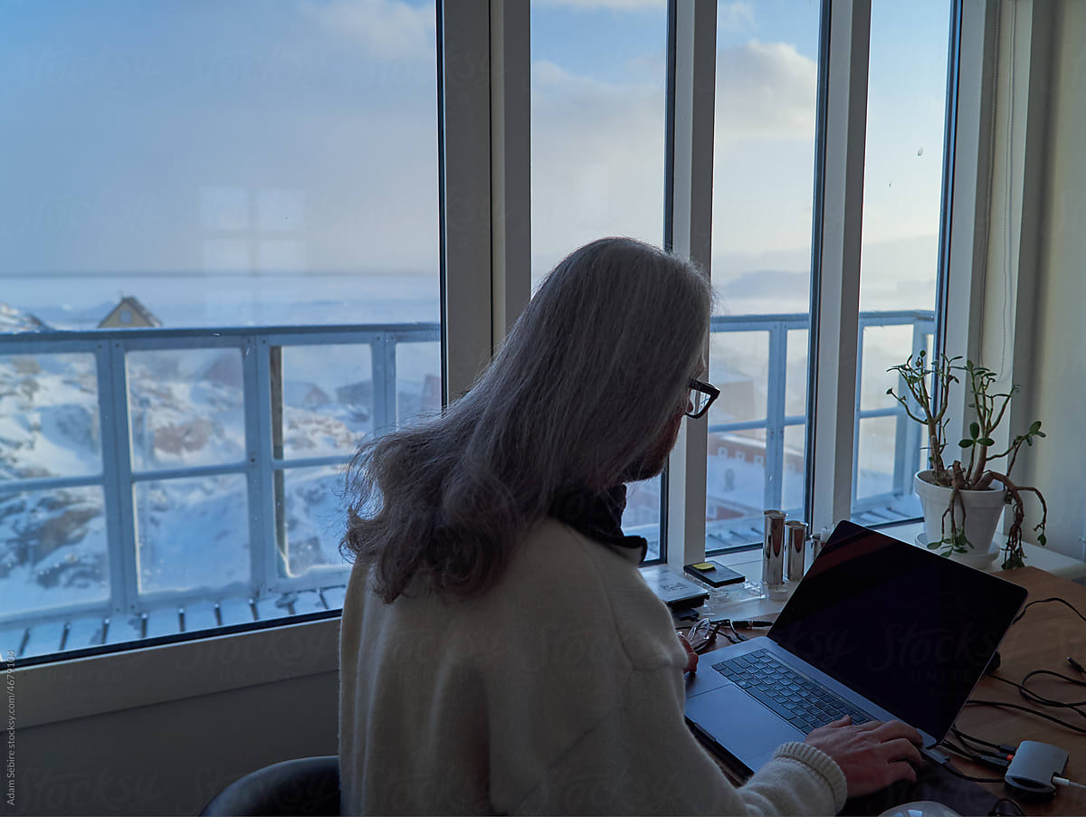 Arctic winter - writer working with inspiring view of fjord