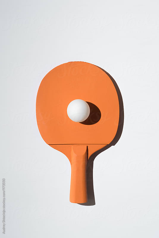 Orange pIng pong racket and white balll/minimalist