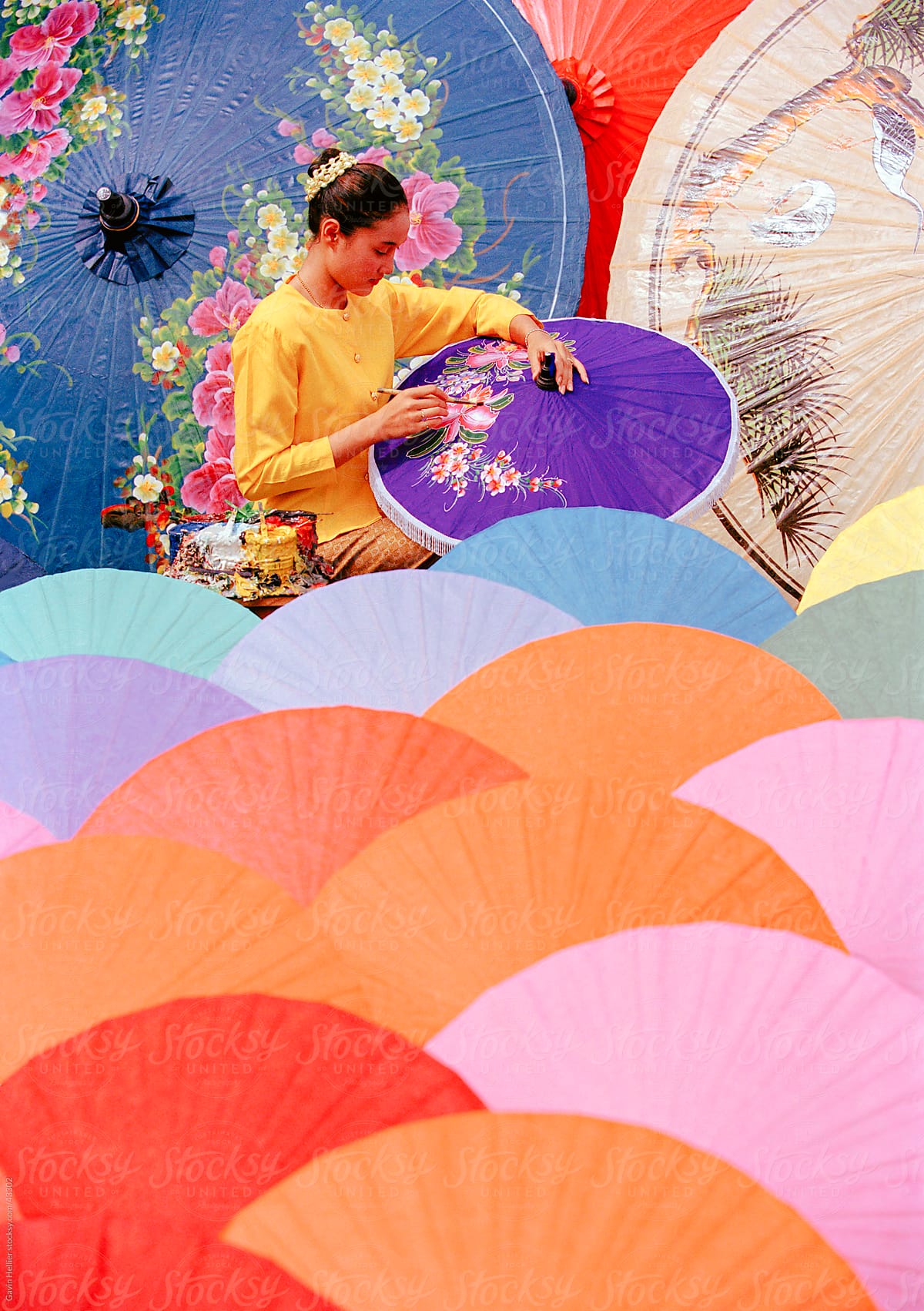 Woman painting umbrellas, Bo Sang umbrella village, Chiang Mai,