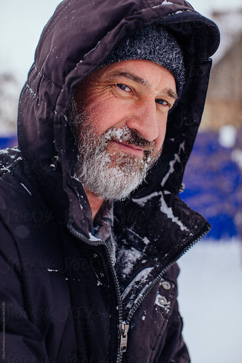 Mature man in warm outwear in winter countryside