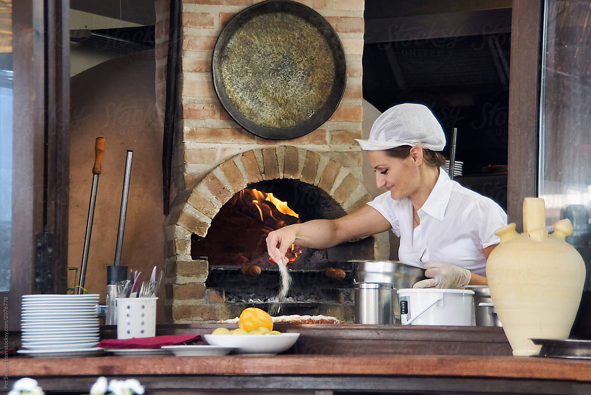 Pizza restaurant: Pizza chef with parmesan pizza