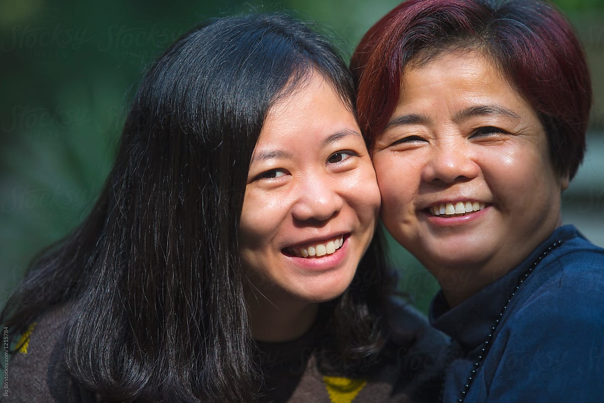 Senior Asian Woman and her Daughter Smile at camera