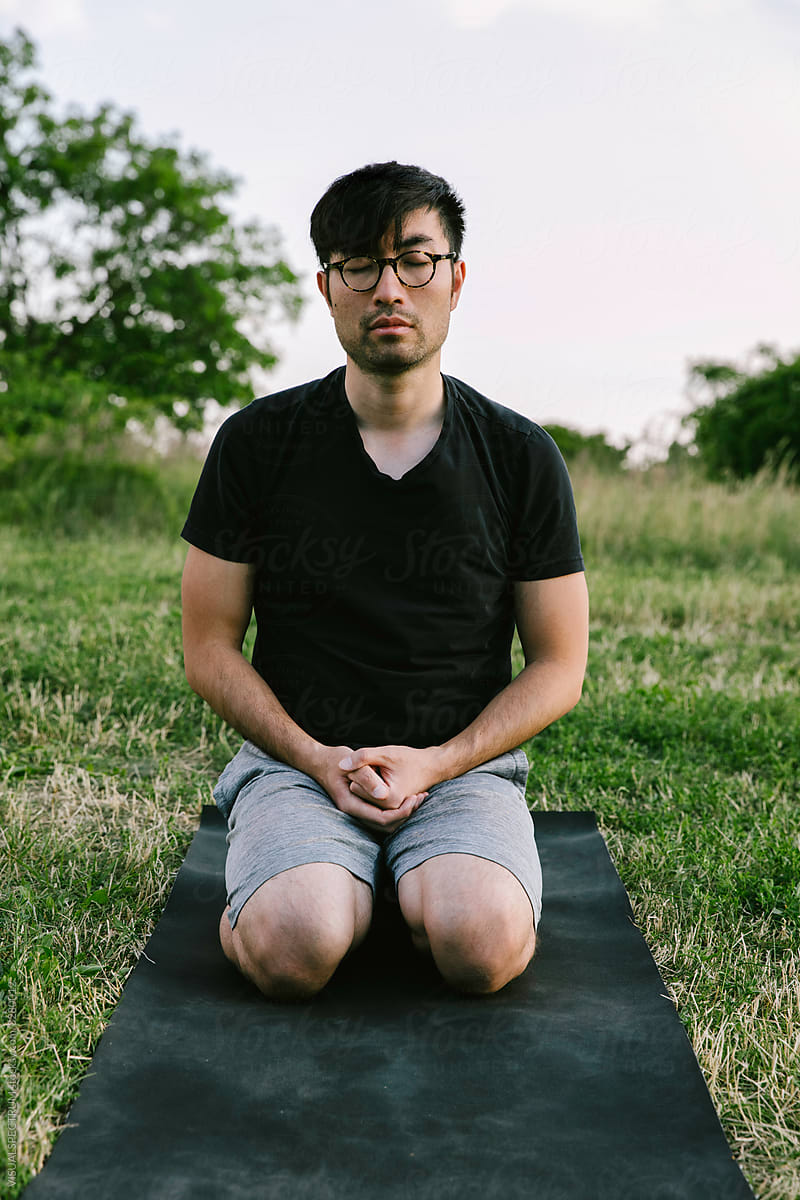 Chinese Man Meditating in Park