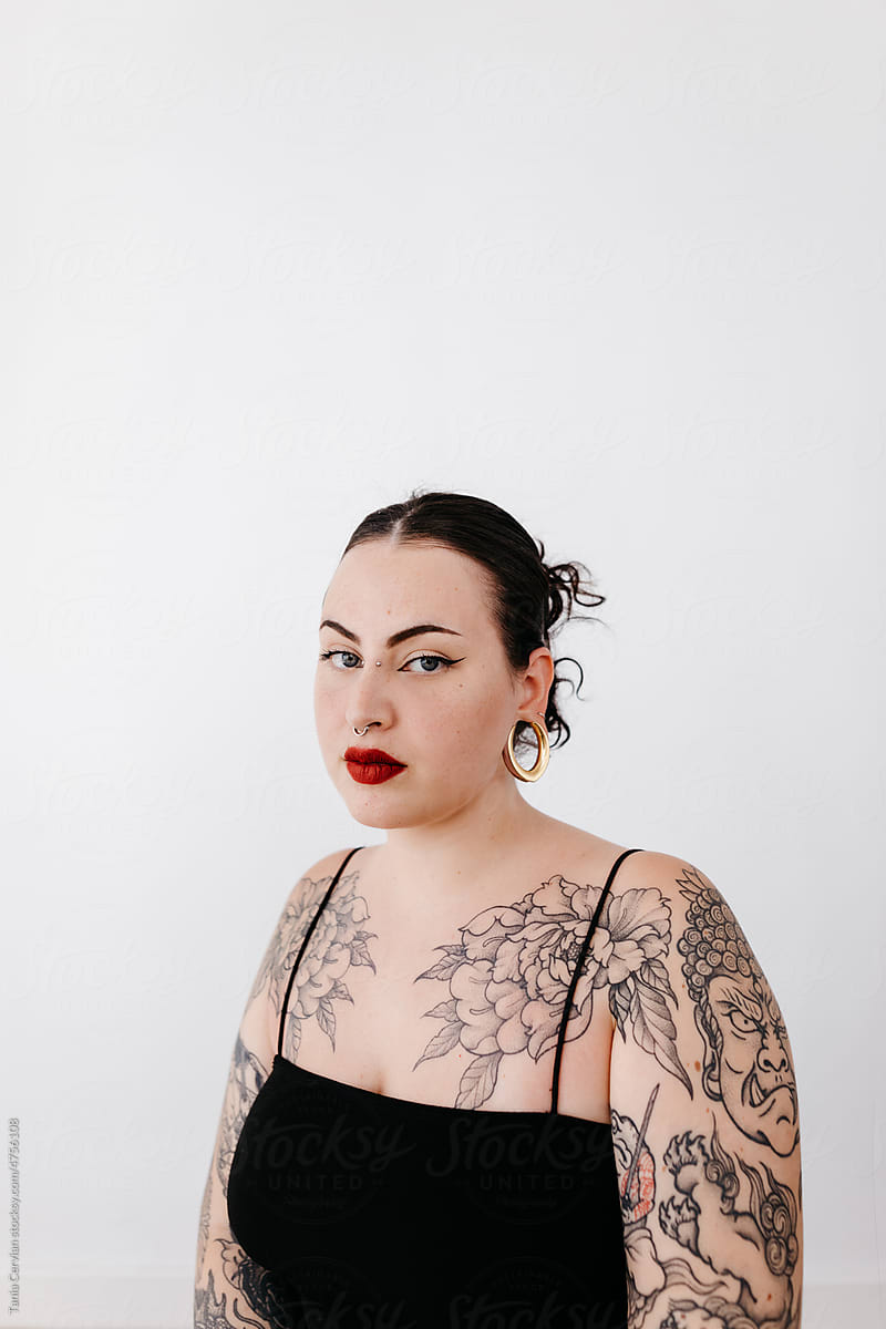 Attractive woman with tattoos in studio
