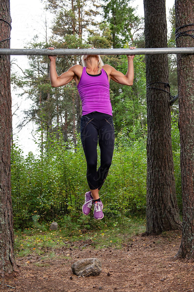 young fit woman doing pullups