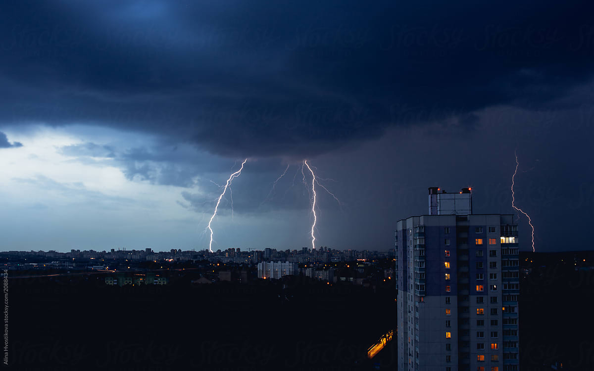 Lightning in stormy sky above dark city
