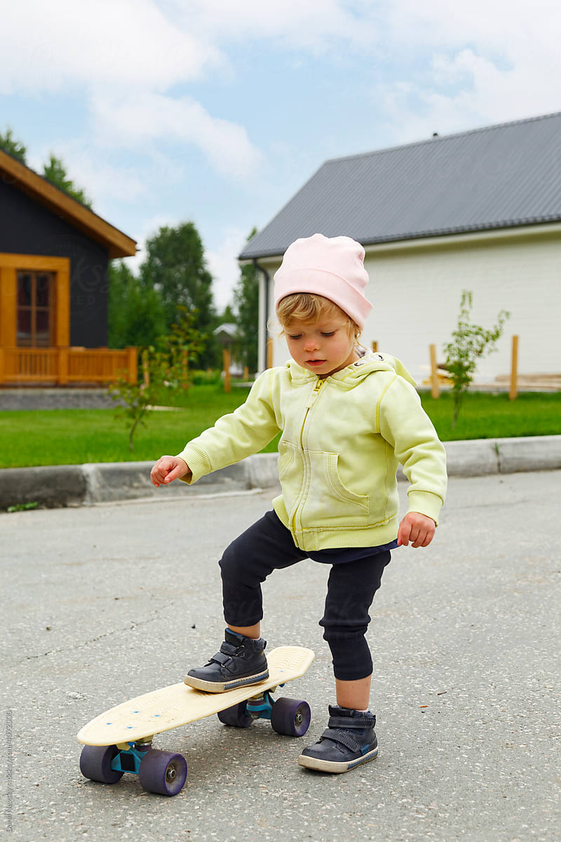 Toddler trying to ride longboard