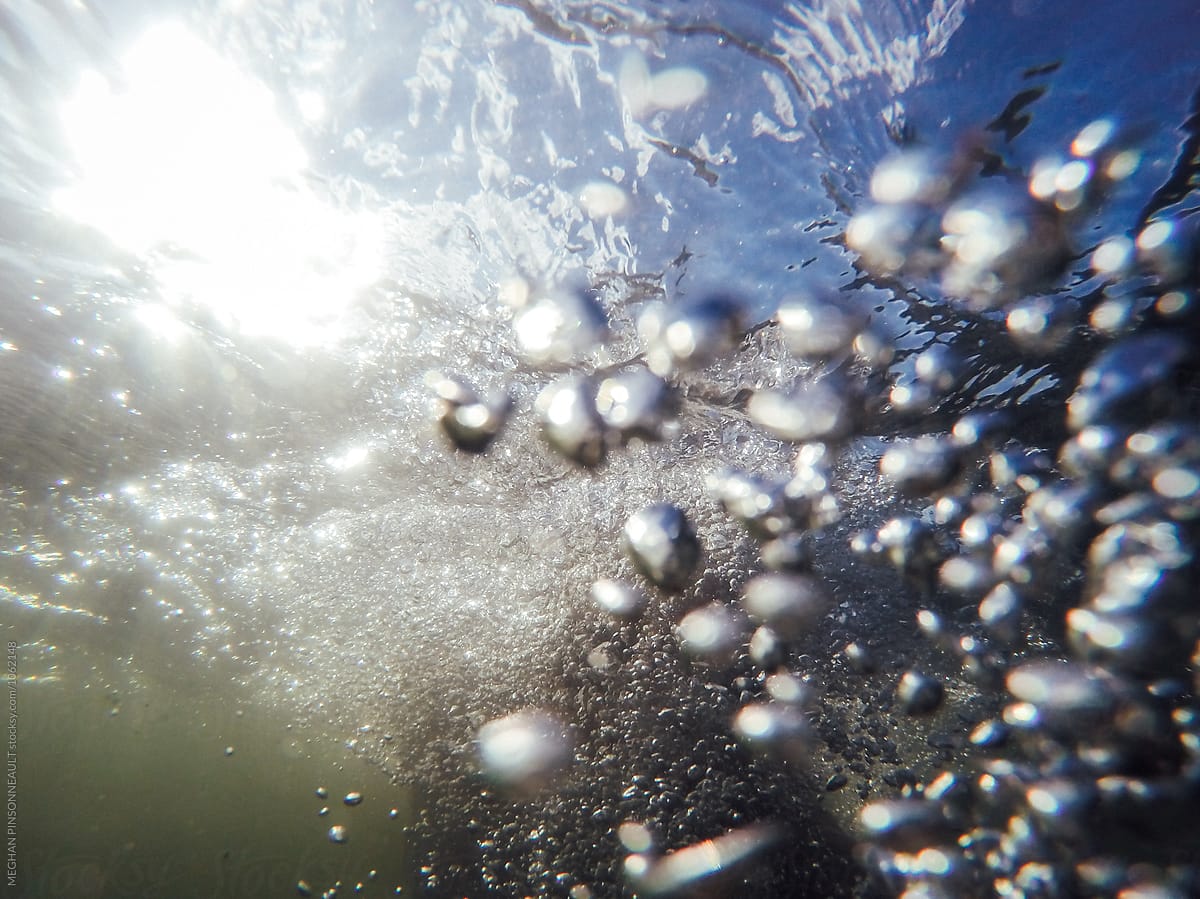 Underwater Bubbles with Blue Sky and Sunlight Shining Through