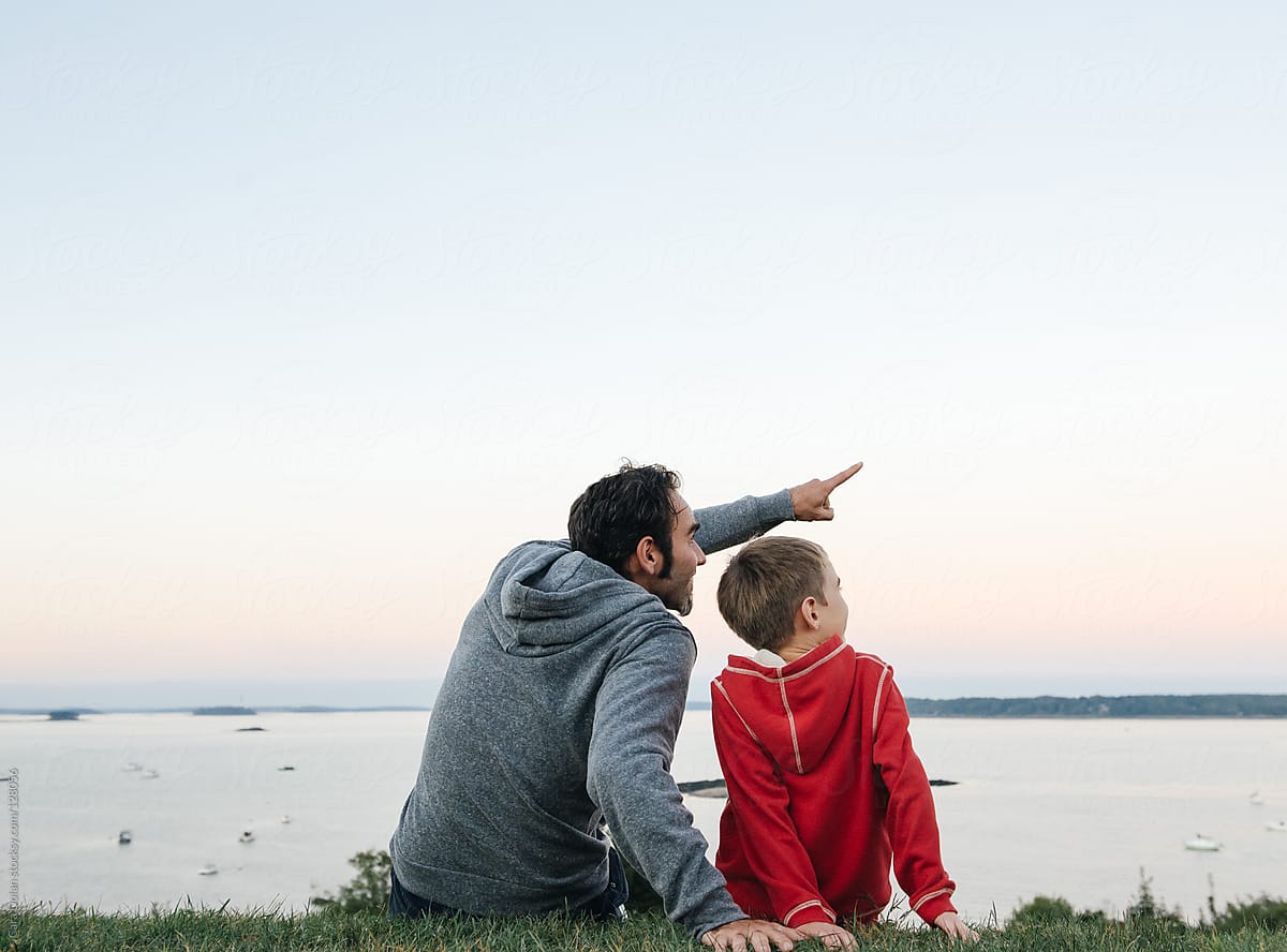 Father Sitting Together with Son Pointing into the Sky by Cara Dolan for St...