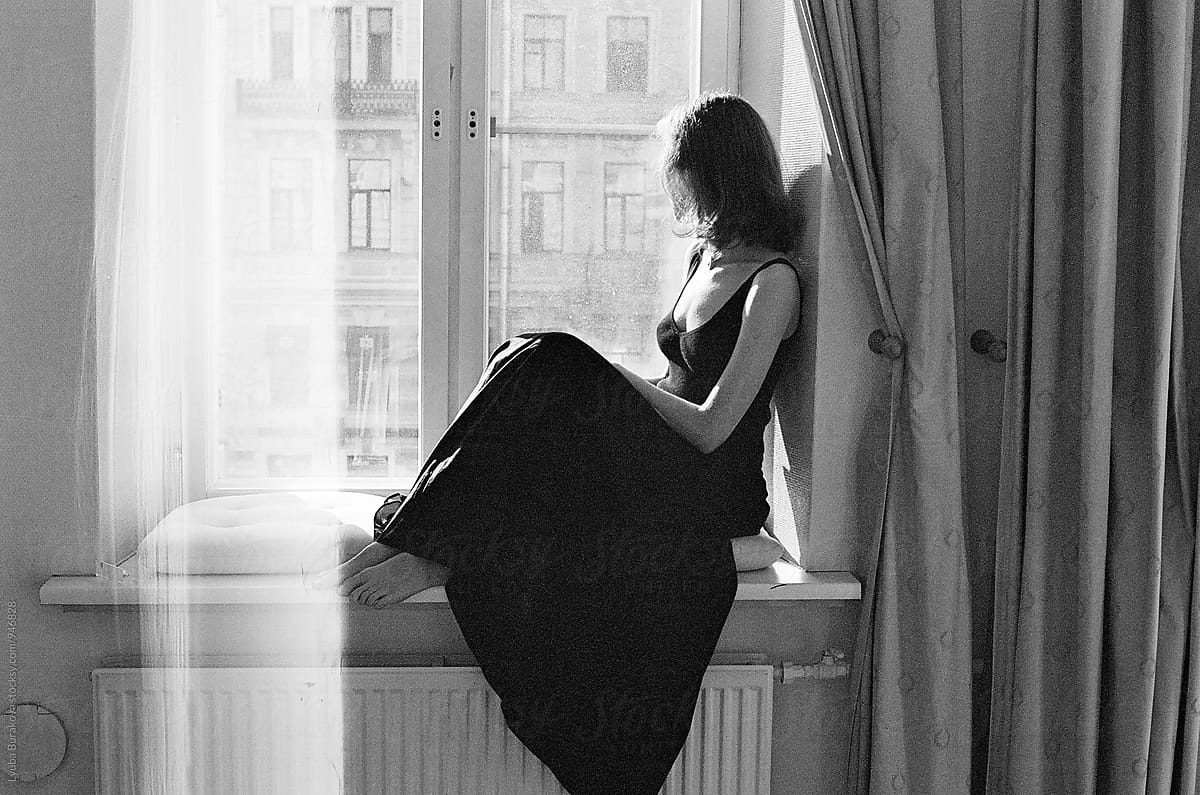 Woman sitting on a windowsill