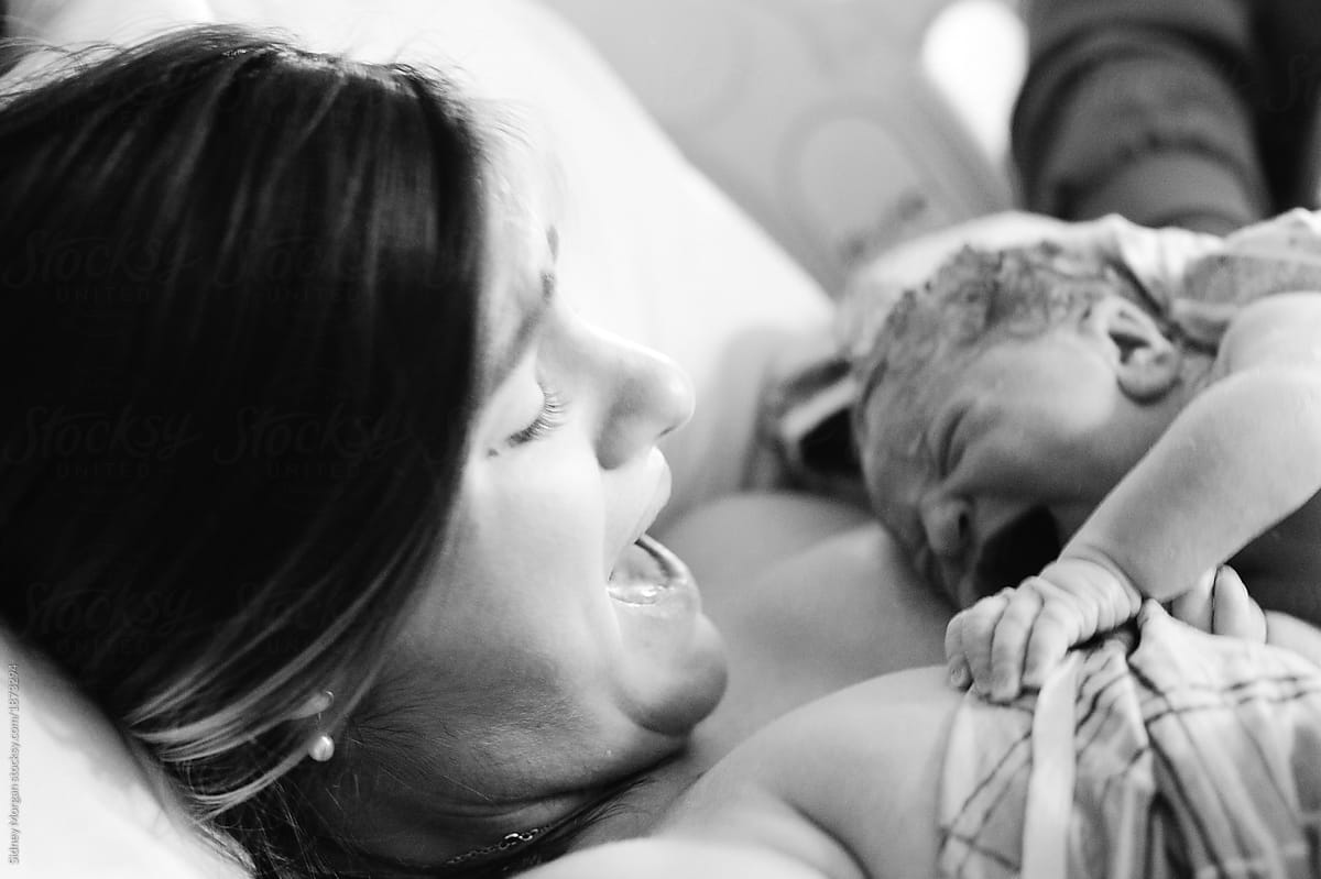 A Blurry Action Photo of A Mother Meeting Her Newborn During Labor