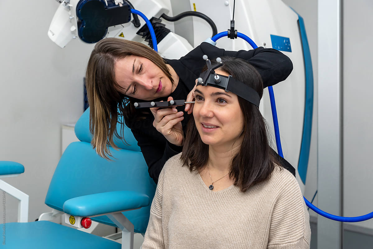 Doctor measuring brain of patient with TMS