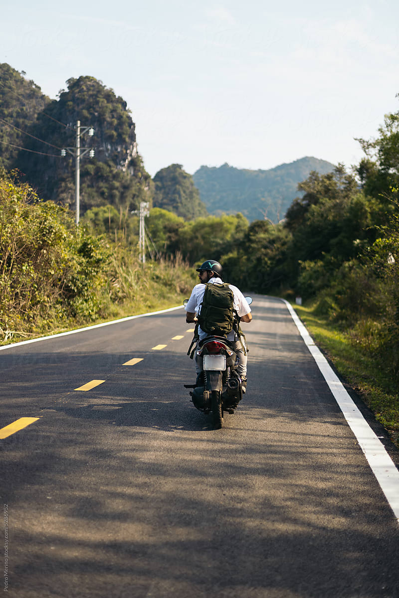 Traveler driving a scooter in the nature of islands of Vietnam
