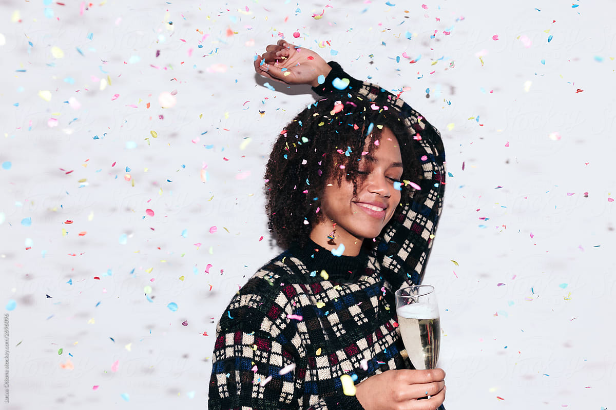 Mixed race woman celebrating a party drinking champagne