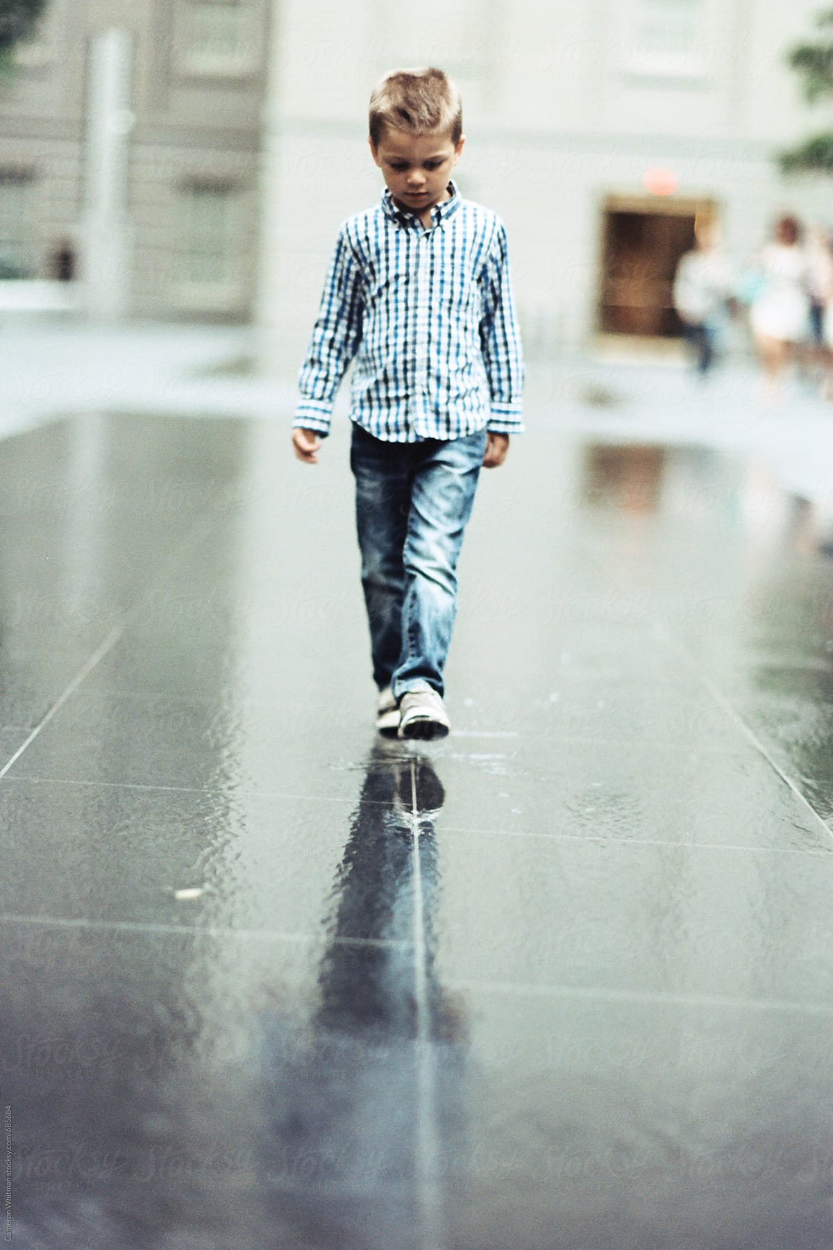 Boy Walking In A Straight Line On Wet Pavement By Stocksy Contributor