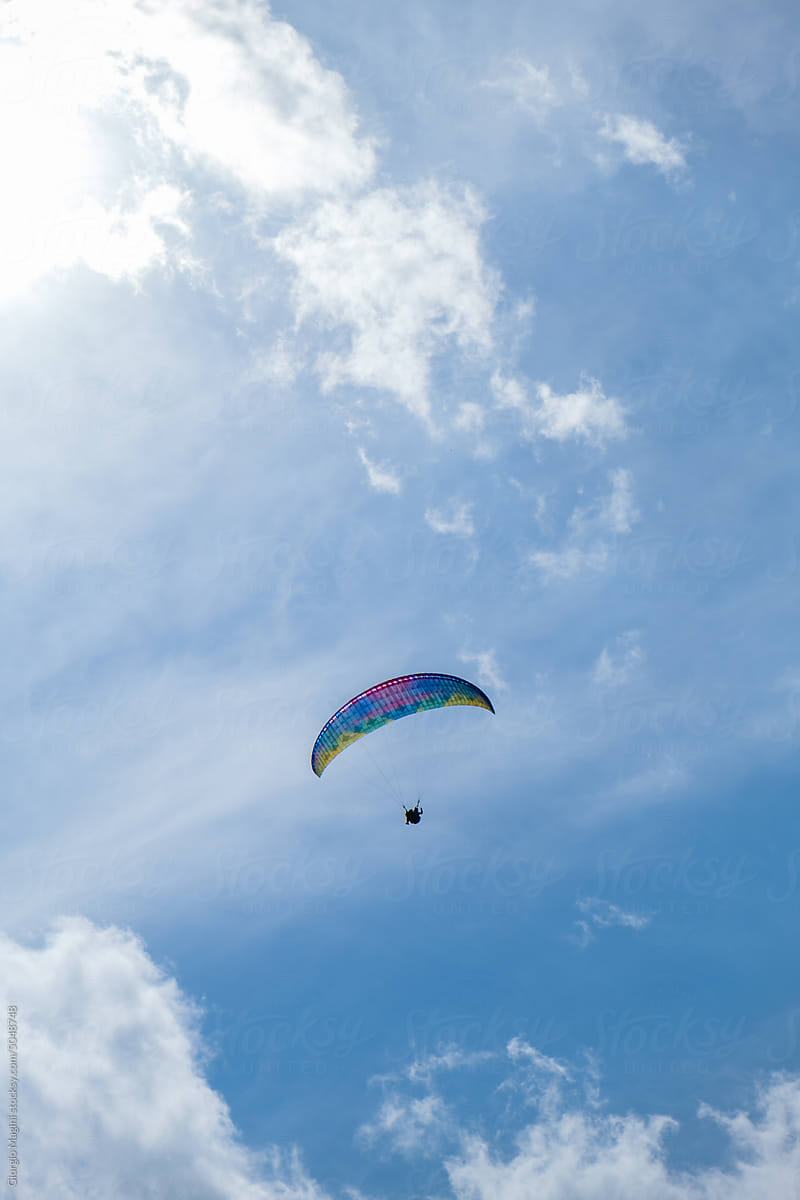 Colorful Paraglider in a Blue Sky with some Clouds