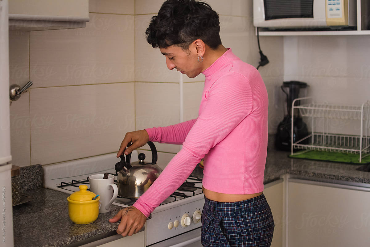 Latino queer person making tea