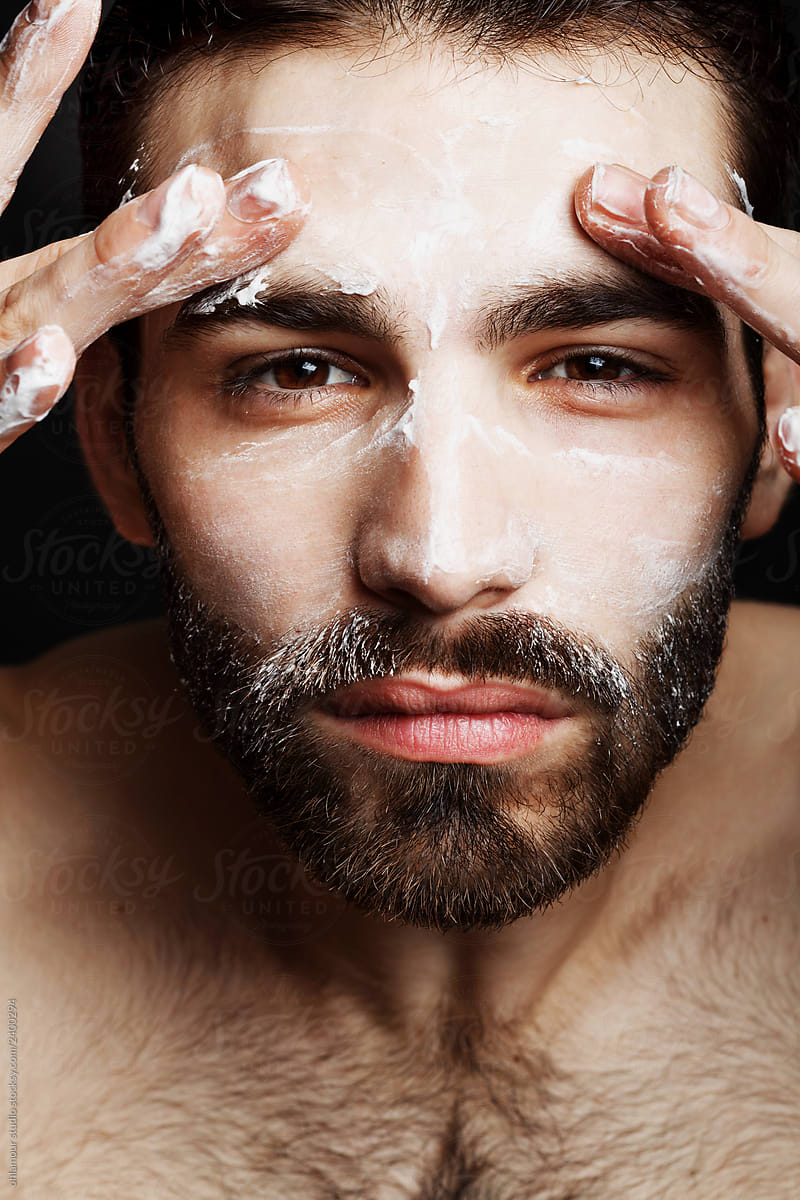 Man using skin lotion