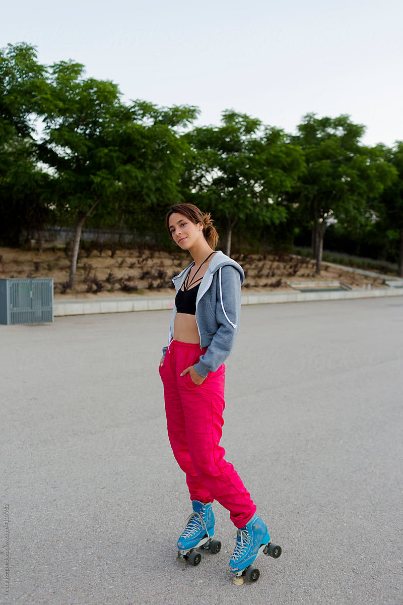 Portrait of attractive roller-skater standing outdoors