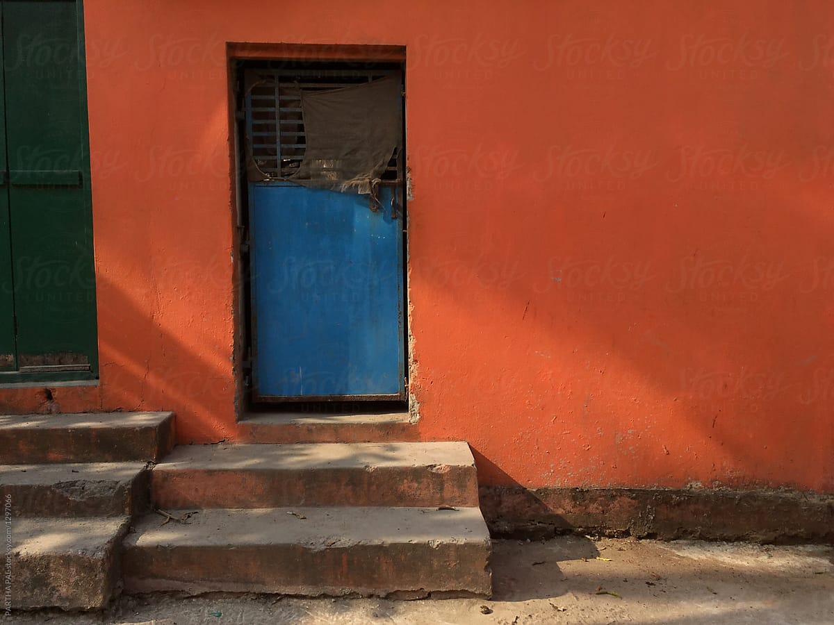 Closed door with stairs and red background