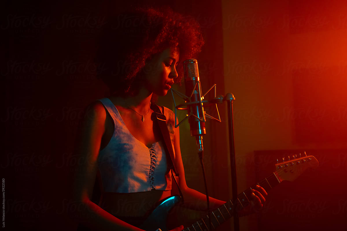 Black Girl Playing The Guitar In The Studio.