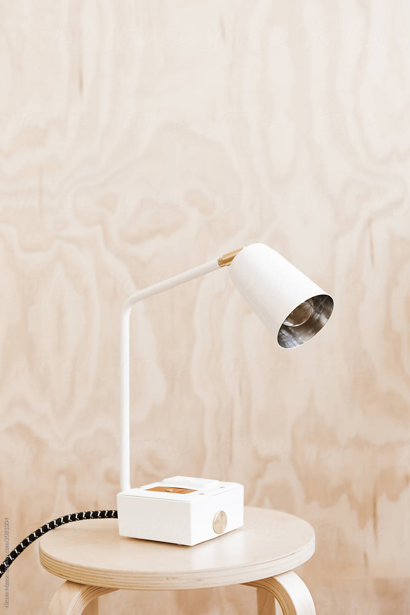 modern white lamp in front of plywood wall