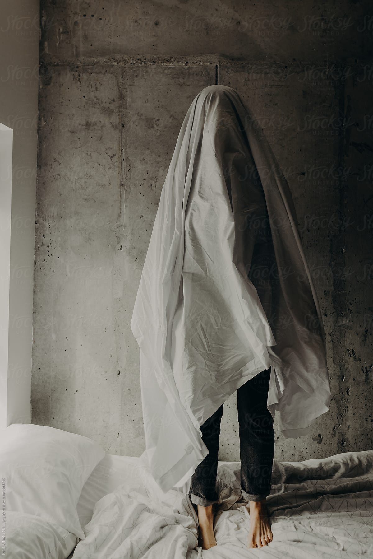 A Sad Ghost Standing Alone On A Messy Bed In A Cement Loft Bedroom By 