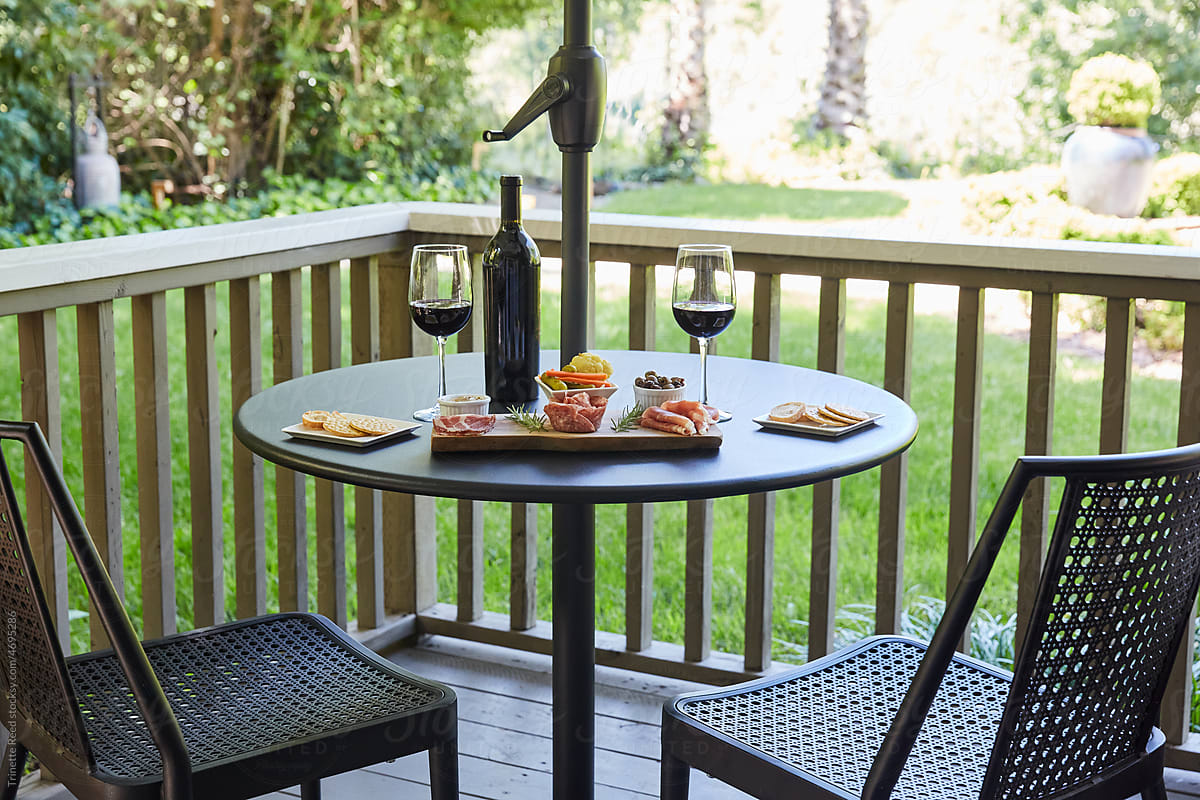Charcuterie Plate with wine on table on outdoor backyard deck