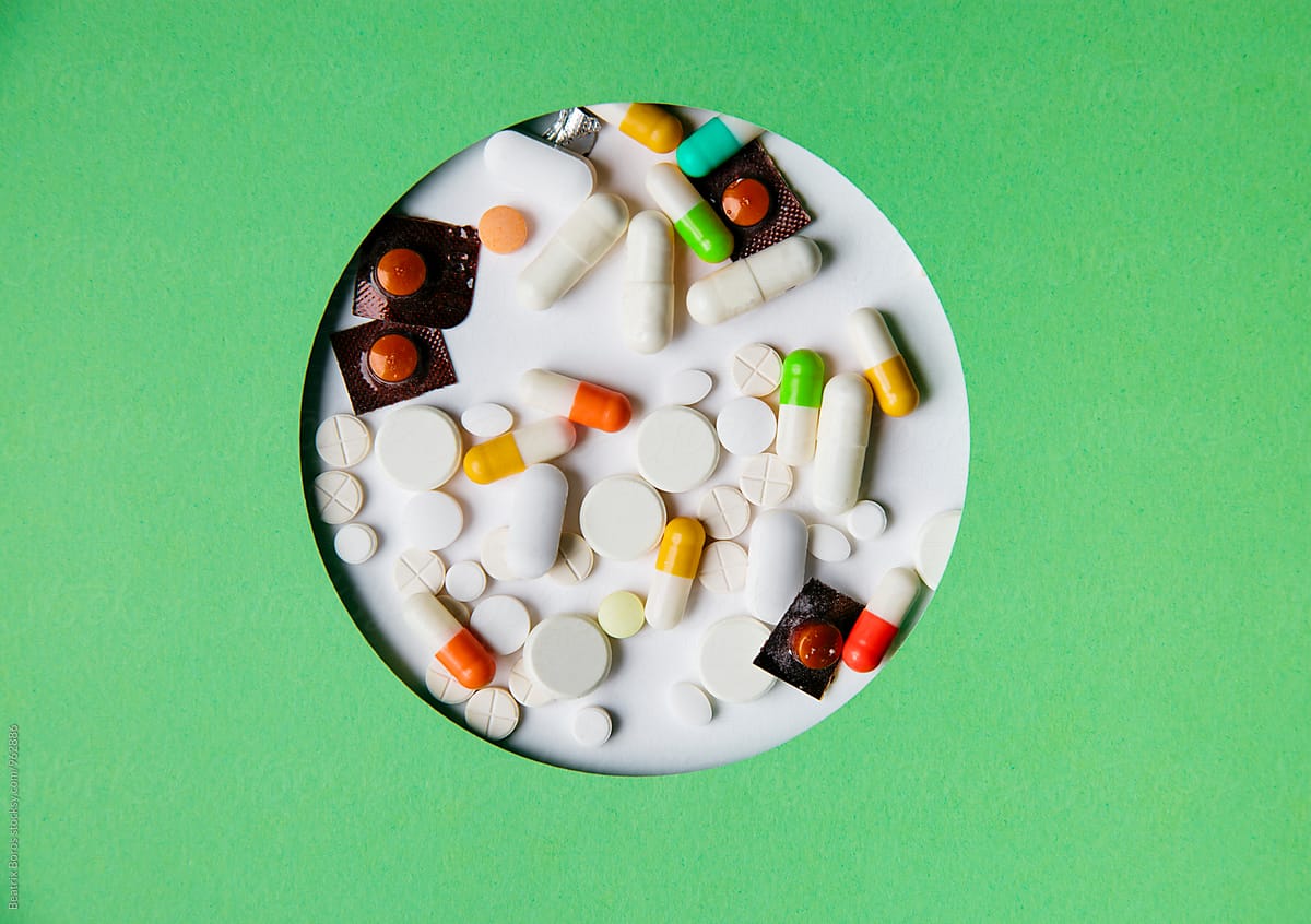 Capsules, pills and medicines in a circular shape with green surface