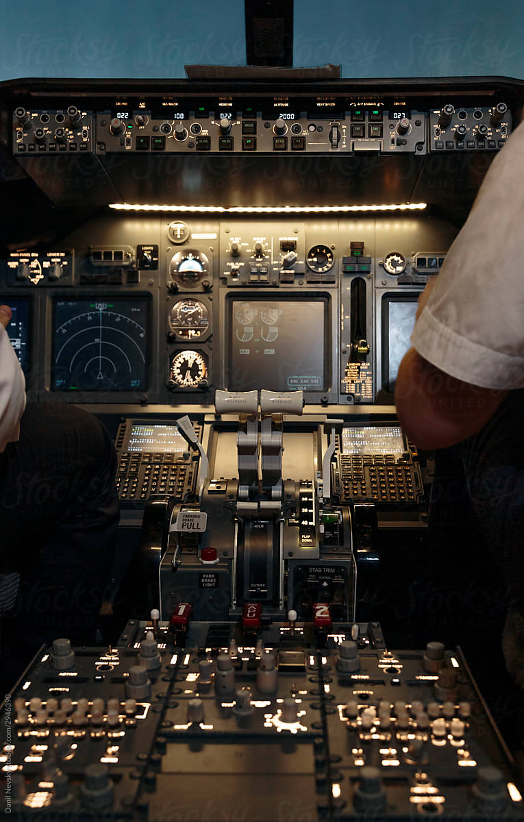 Pilots and airplane instruments in cockpit