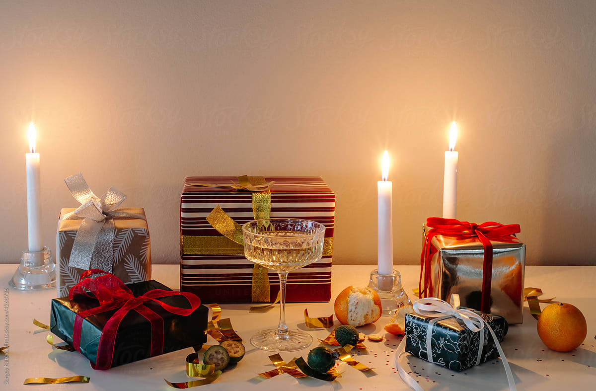 New Year gifts with candles on table