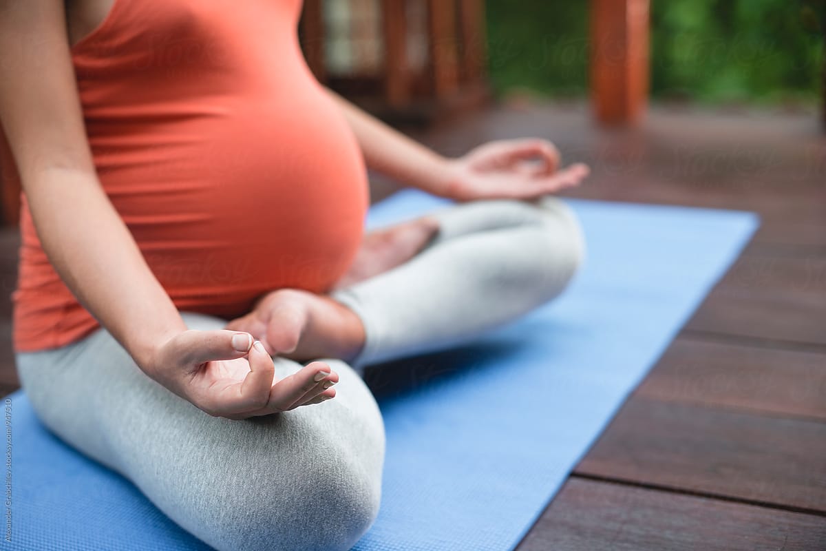 Pregnant Woman Meditate In A Yoga Pose