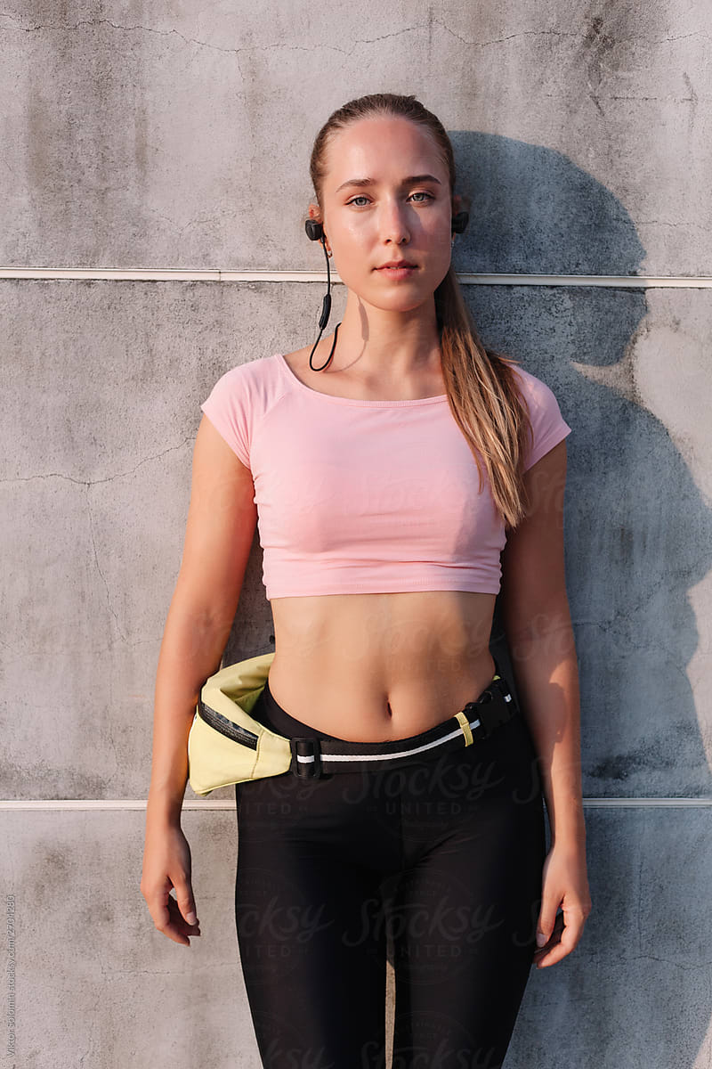Summer sport street style portrait of young beautiful runner athlete woman
