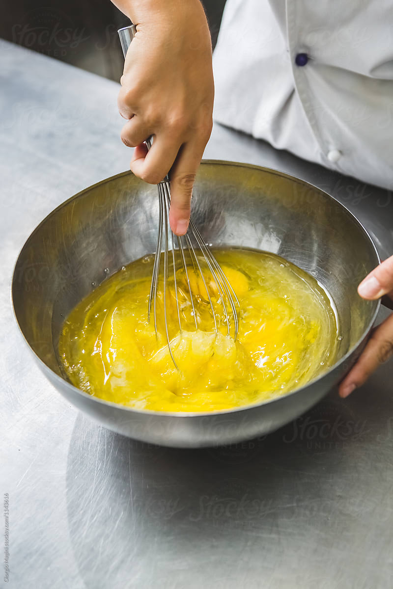 Pastry Chef Stirring Eggs with a Wire Whisk