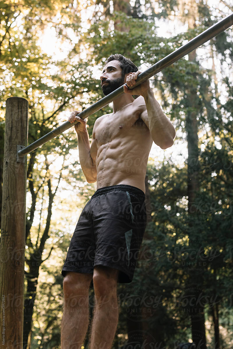 Young Man Exercising Outdoors In Nature on